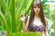 A woman in a bikini standing next to a pond.