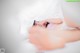 A woman laying in bed under a white sheet.