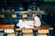 A woman laying on top of a wooden table.